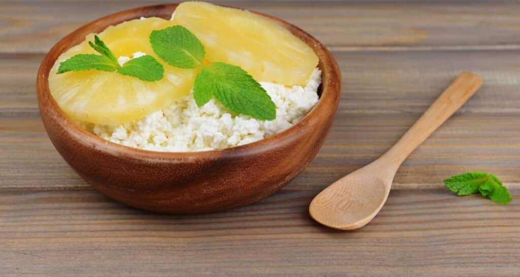 cottage cheese with pineapple in a wood bowl